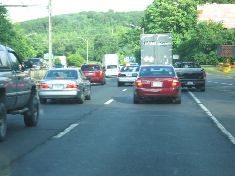 2001 Ford Crown Victoria - Photo of multiple lanes of highway traffic including cars and a box truck.