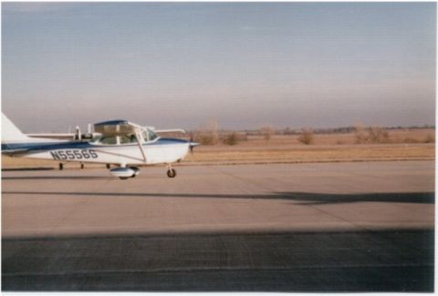1998 Ford Taurus - An airplane sits on a tarmac under a clear sky.