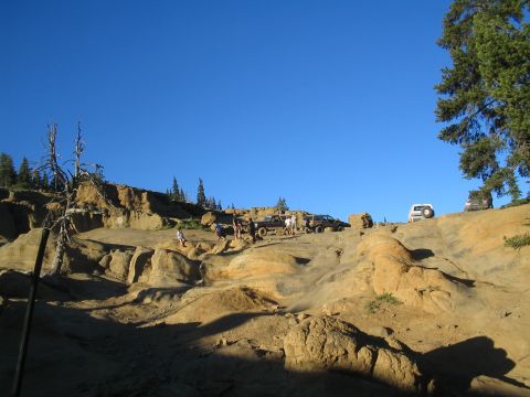1989 Ford Bronco - Off-road vehicles gather on a challenging rocky terrain during an outdoor event.