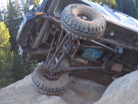 1989 Ford Bronco - Vehicle stuck on rocks, highlighting its undercarriage and suspension system.