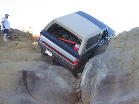 1989 Ford Bronco - A Ford Bronco maneuvers through a challenging rocky terrain.