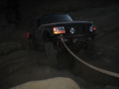 1989 Ford Bronco - This 1989 Ford Bronco is navigating a challenging rocky trail at night.
