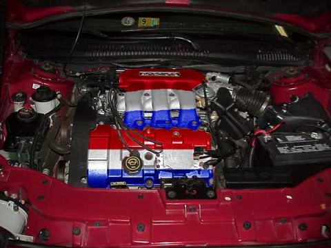 1998 Ford Taurus - Engine bay with custom red, white, and blue painted engine components.