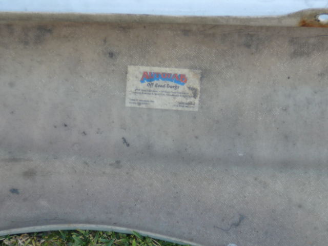 Fiberglass part with a sticker for Autofab Off Road Trucks