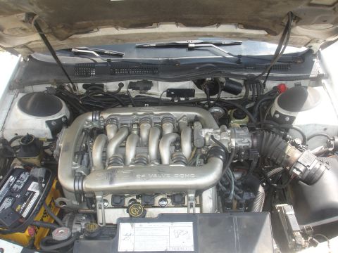 1990 Ford Taurus - Engine bay view showing the V6 24 valve DOHC engine and surrounding components.