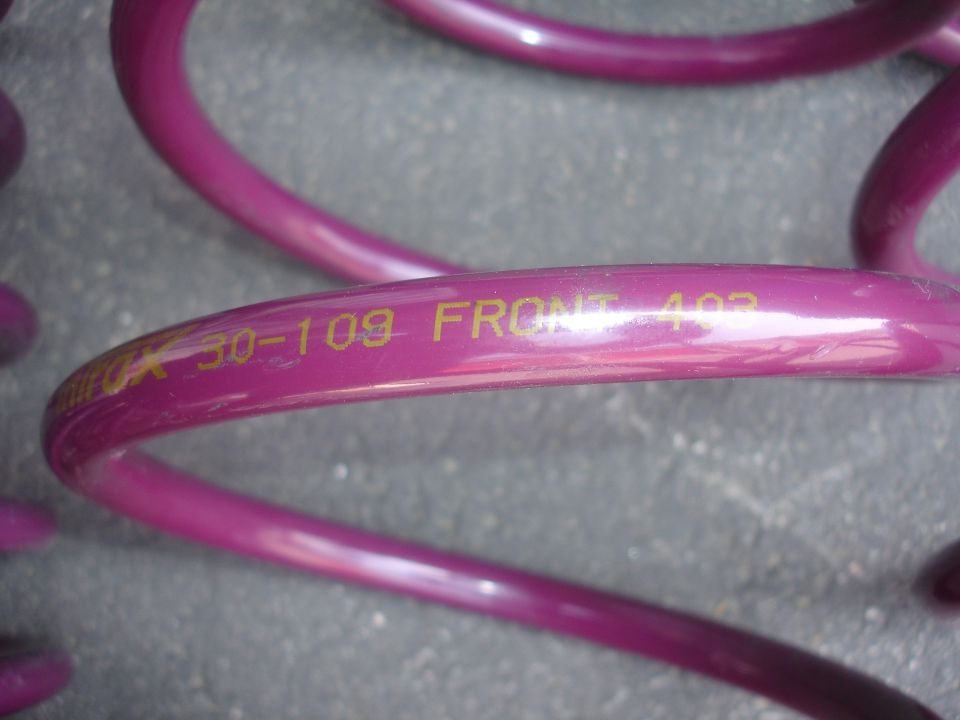 Close-up of purple coil springs with yellow text reading '30-109 FRONT 403'