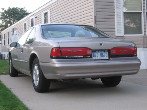1995 Ford Thunderbird - Rear view of a 1995 Ford Thunderbird LX parked in front of a mobile home.