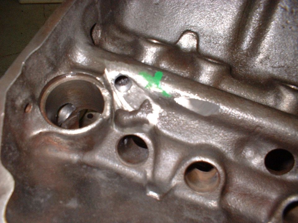 Close-up of engine block interior with cylinder bore and oil passages visible.