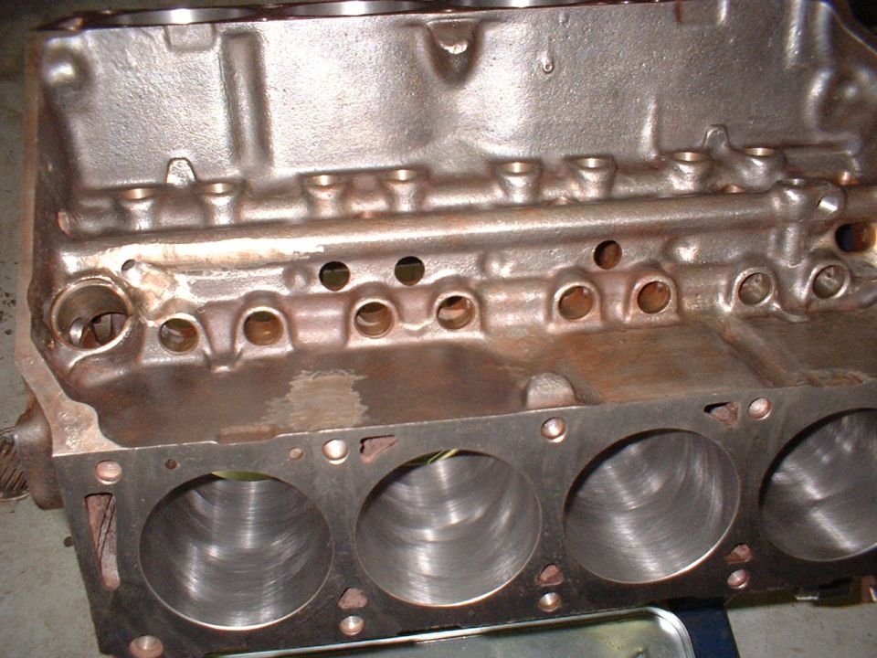Cast iron V8 engine block with cylinders visible