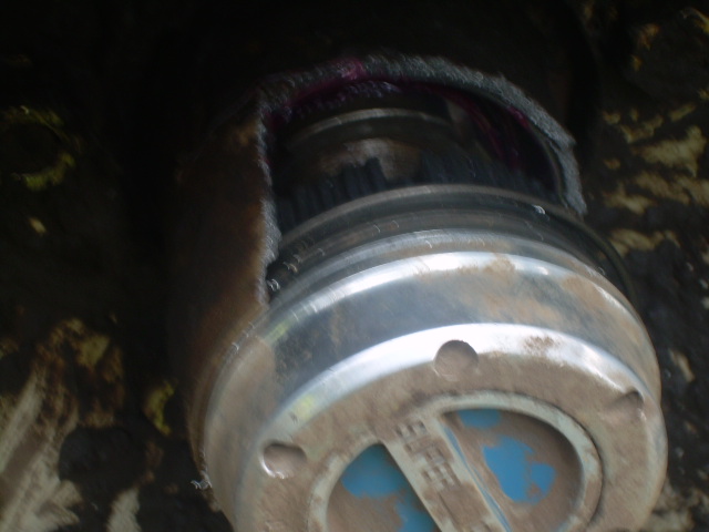 Damaged hub assembly with grease and metal components.