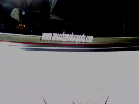 1998 Ford Taurus - A sticker on a car window displays a website address, with a Supermotors logo visible at the bottom.