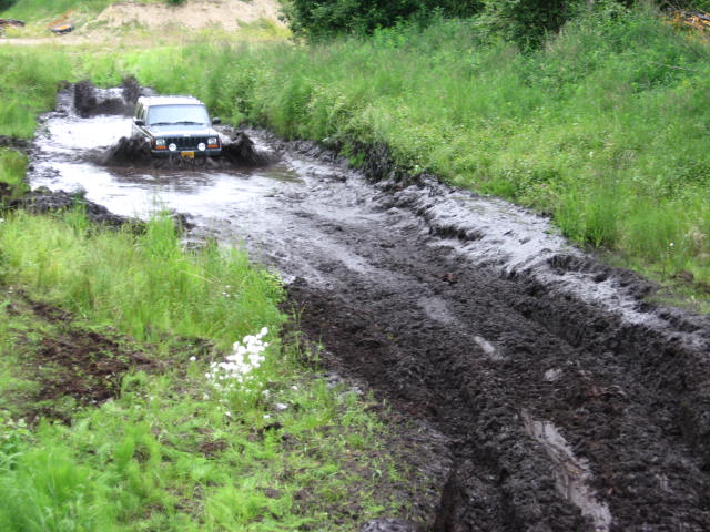 SUV driving through mud