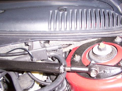 1998 Ford Taurus - This image shows various parts of a car's engine bay, including hoses and a strut tower mount.