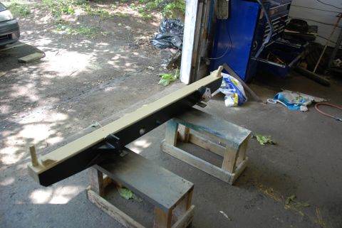1996 Ford Bronco - Photograph of a painted vehicle bumper or crossmember drying on sawhorses, not a technical document.