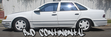 1993 Ford Taurus - A white sedan is shown from the side, parked on a street with a white fence in the background.