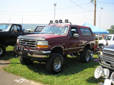 1995 Ford Bronco - Maroon 1995 Ford Bronco modified for off-road use, seen at an outdoor event.