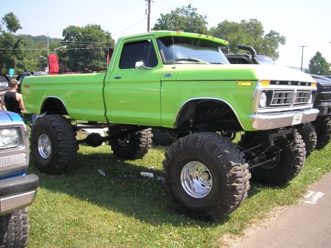 1995 Ford Bronco - This lifted 1975 Ford pickup truck features a bright lime green paint job and massive off-road tires.