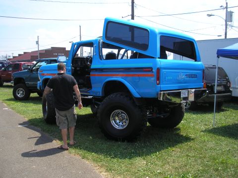 1995 Ford Bronco - This lifted blue Ford Bronco features distinctive orange stripes and "Big Thunder" badging on the tailgate.