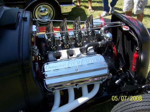 1973 Ford Mustang - Close-up of a highly modified V8 engine with chrome valve covers reading "Chrysler Fire Power", multiple carburetors, and custom exhaust he…