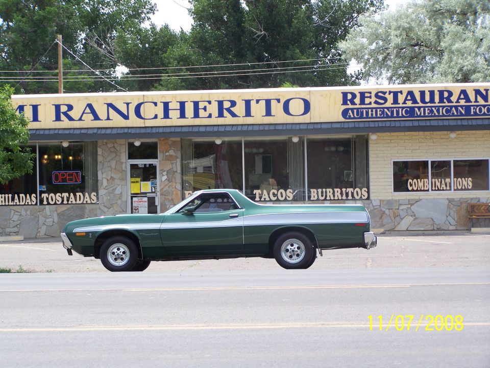Green 1970s pickup truck with silver stripe in front of Mi Rancherito Mexican Restaurant.