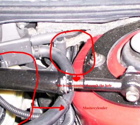 1998 Ford Taurus - Close-up view of engine components, including hoses and a wire, with red markings indicating specific areas.