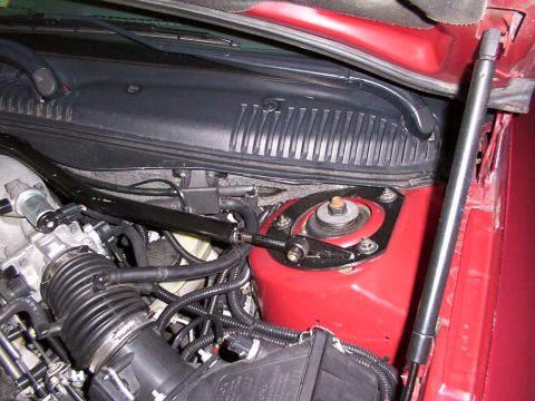 1998 Ford Taurus - Close-up view of the engine bay, focusing on the strut tower and intake manifold components.