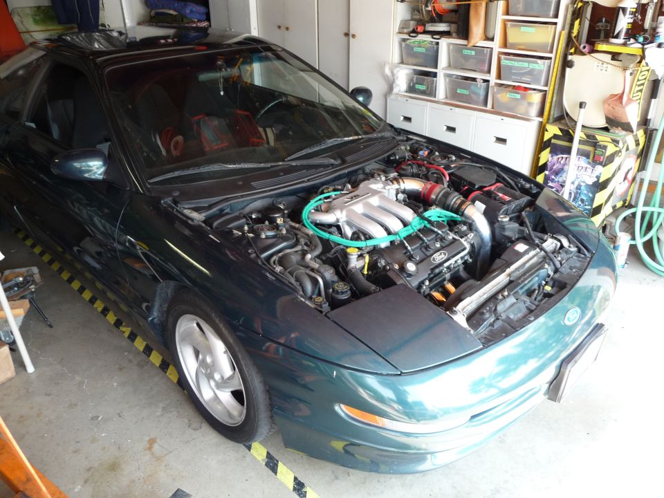 1996 Ford Probe in a garage with hood open, showing the engine.
