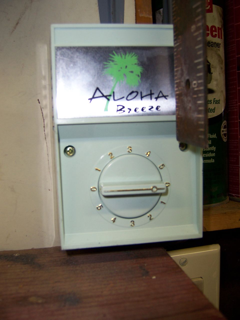 Aloha Breeze fan speed control dial mounted on a garage wall