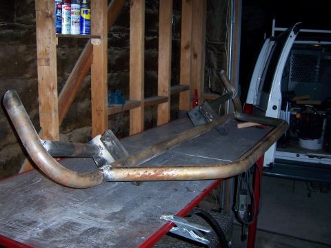 1991 Ford Bronco - Photograph of a welded steel tube fabrication on a garage workbench, not a technical document.