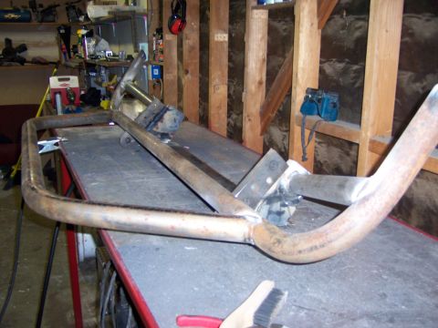 1991 Ford Bronco - Photograph of a welded tubular steel fabrication in a garage, not a technical document.