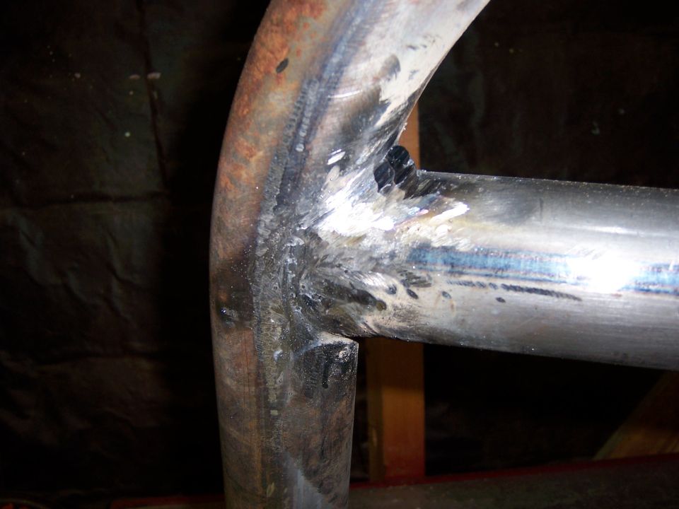 Close-up of a welded metal tube attached to a bracket