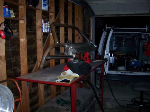 1991 Ford Bronco - Custom bumper fabrication in progress, with a van visible in the garage.