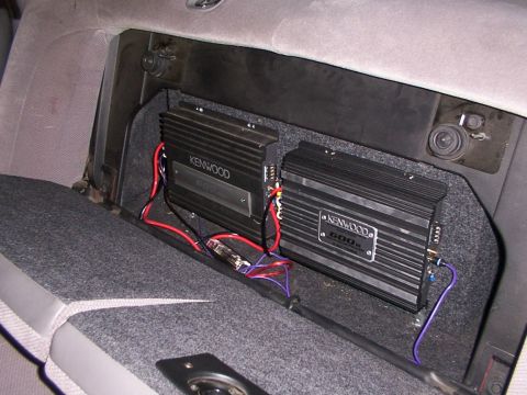 1998 Ford Taurus - Two car audio amplifiers are wired and mounted in a custom enclosure within the vehicle's interior.
