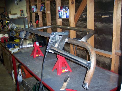 1991 Ford Bronco - Custom bumper fabrication in progress on jack stands in a workshop setting.