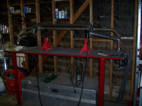 1991 Ford Bronco - A custom front bumper is being fabricated on a workbench in a garage setting.