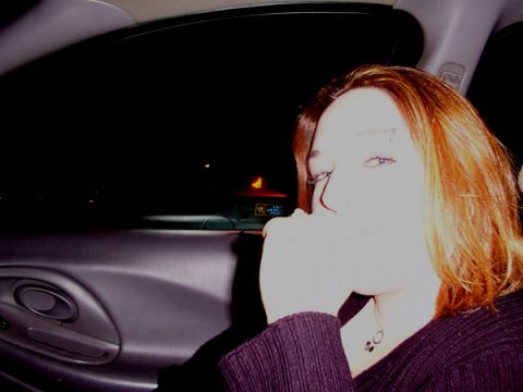 1998 Ford Taurus - Interior shot of a woman in a car at night, with the door panel visible.
