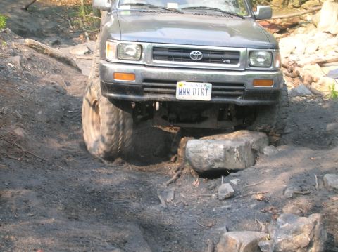 1996 Ford Bronco - This Toyota 4Runner navigates a challenging off-road course, demonstrating its capability on rough terrain.