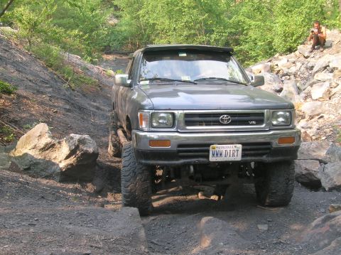 1996 Ford Bronco - This Toyota pickup truck is equipped for off-road adventures, tackling a challenging rocky path.