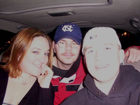 1998 Ford Taurus - A group of friends pose for a photo inside a vehicle.
