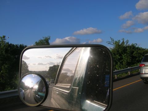 1996 Ford Bronco - Reflection in the side mirror shows a highway scene with other vehicles and a silver SUV in the adjacent lane.