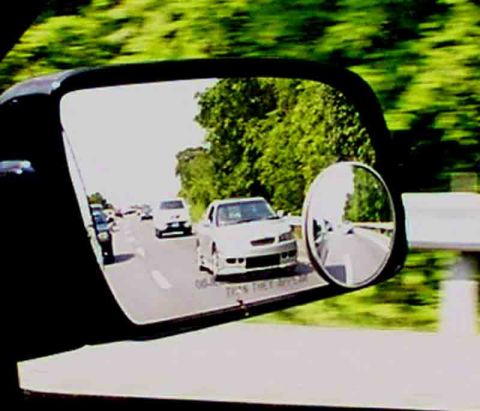 1998 Ford Taurus - View of traffic on a highway through a car's side mirror.