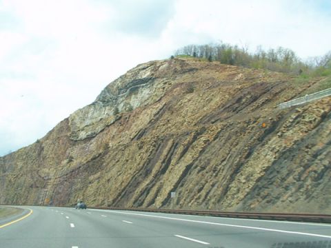 1998 Ford Taurus - A highway runs alongside a massive, geologically interesting rock face.