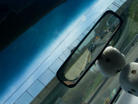 1998 Ford Taurus - View through the windshield and interior mirror shows highway traffic and fuzzy dice.