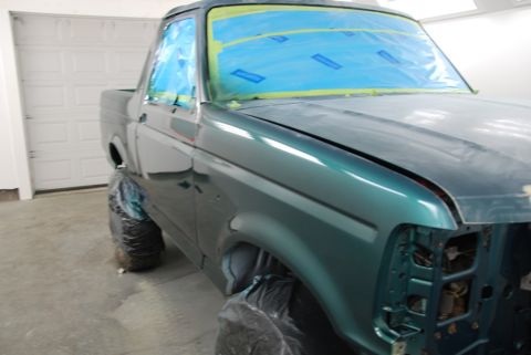 1996 Ford Bronco - A dark green Ford pickup truck is shown from the front quarter angle, possibly an older generation model.