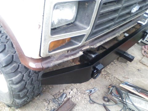 1982 Ford Bronco - Close-up view of the front grille and fender area of a vehicle, showing some wear and tear.