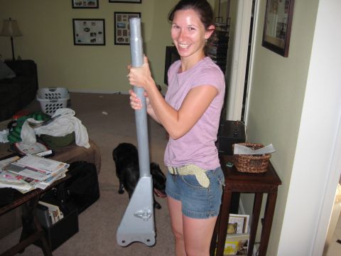 1995 Ford Bronco - A woman holds a large metal pole indoors, with a dog visible in the background.