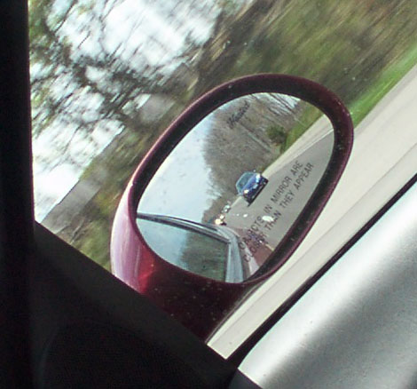 1998 Ford Taurus - Objects in the side mirror are closer than they appear, as seen in this reflection of a blue car.