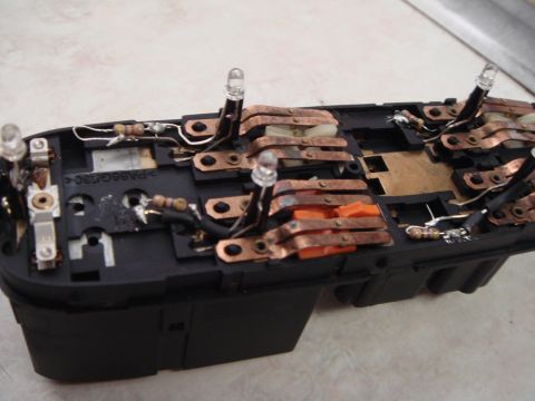 1998 Volvo V70 - This is a close-up view of a car's interior light switch assembly, showing its internal components and wiring.