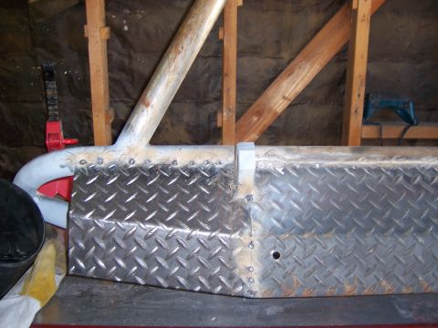 1991 Ford Bronco - Close-up of a custom fabricated front bumper, diamond plate and metal tubing construction.