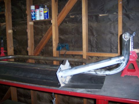 1991 Ford Bronco - Custom bumper fabrication in progress, supported by a jack stand.